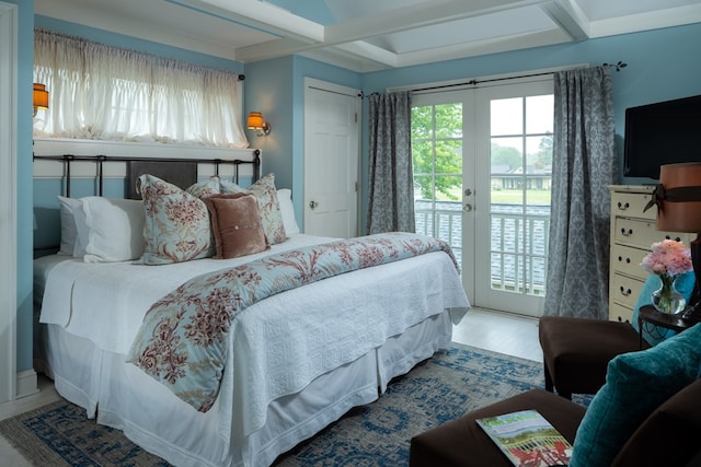 bedroom featuring access to exterior, french doors, beamed ceiling, and hardwood / wood-style flooring