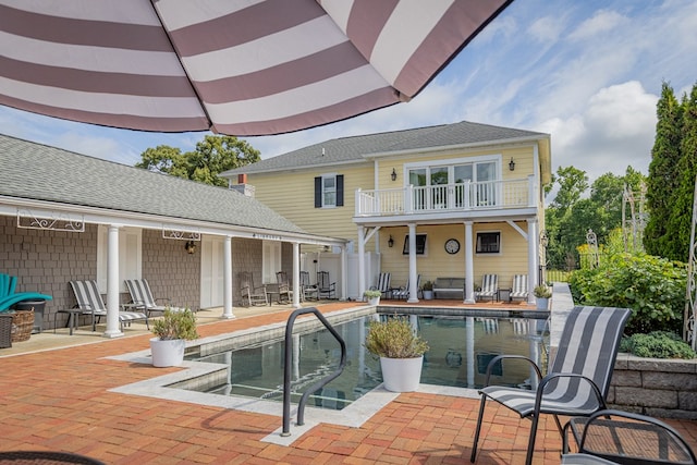 back of house featuring a patio area and a balcony