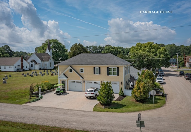 view of front of property featuring a garage and a front lawn