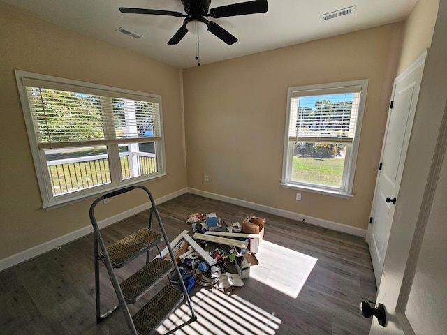 interior space featuring dark wood-type flooring and ceiling fan