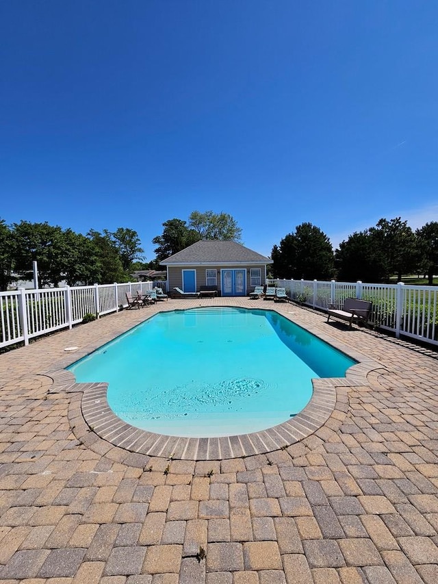 view of pool featuring an outdoor structure and a patio