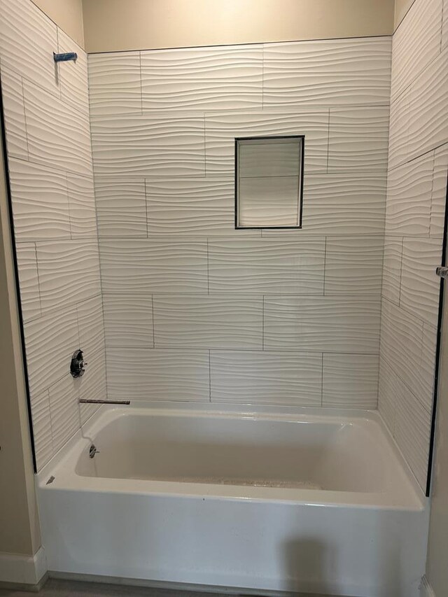 bathroom with hardwood / wood-style flooring and tiled shower