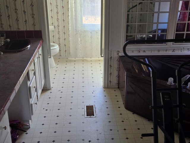 11012 River Rd, Mollusk, VA 22503 - bathroom with visible vents, wallpapered walls, tile patterned floors, toilet, and vanity