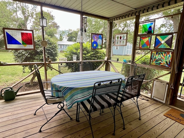 sunroom / solarium with outdoor dining area and cooling unit