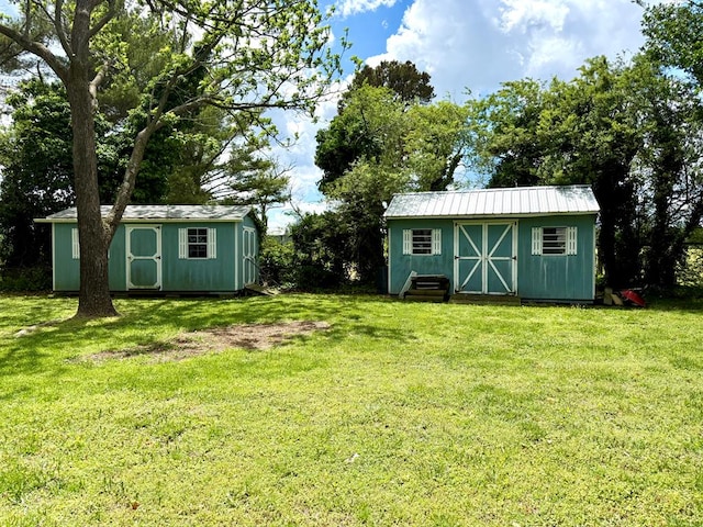 view of yard with an outbuilding and a shed