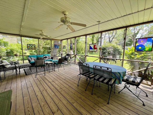 sunroom / solarium with ceiling fan and an outdoor living space