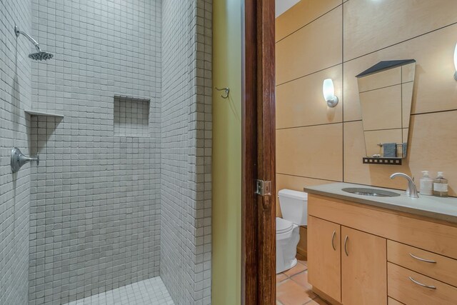 783 King Carter Dr, Irvington, VA 22480 - bathroom featuring tile patterned floors, vanity, toilet, and a tile shower