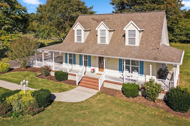 country-style home with covered porch and a front lawn