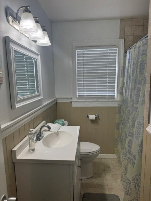2266 Hayes Rd, Hayes, VA 23072 - full bathroom featuring vanity, a wainscoted wall, a shower with curtain, and tile patterned floors