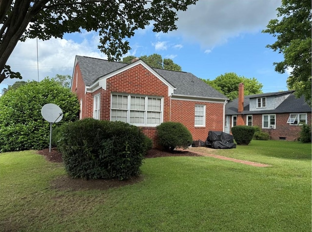 2266 Hayes Rd, Hayes, VA 23072 - view of property exterior with brick siding, a yard, and a shingled roof