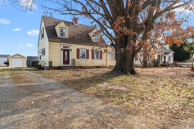 cape cod house with an outbuilding and a garage