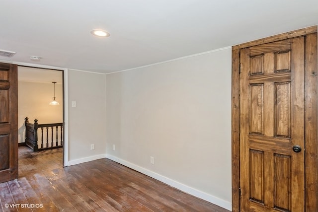 empty room with dark hardwood / wood-style flooring