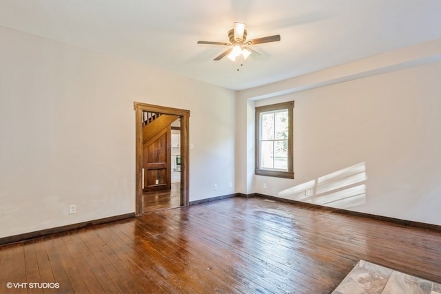 unfurnished room with dark hardwood / wood-style flooring and ceiling fan