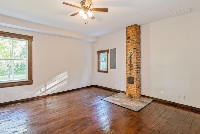 unfurnished living room featuring electric panel, dark hardwood / wood-style floors, and ceiling fan