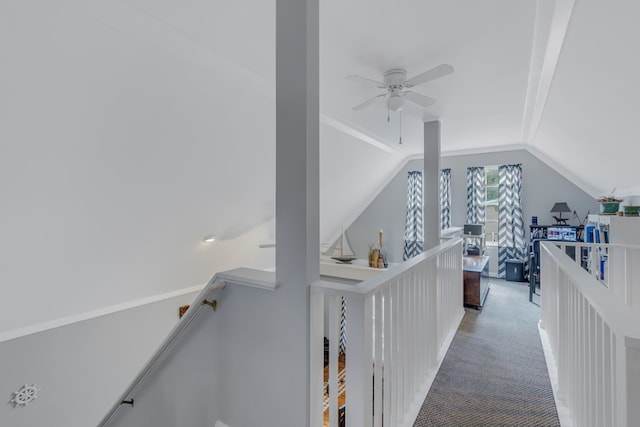 hallway with carpet flooring and lofted ceiling