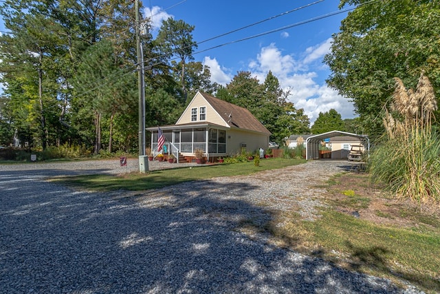 country-style home featuring a sunroom and a carport