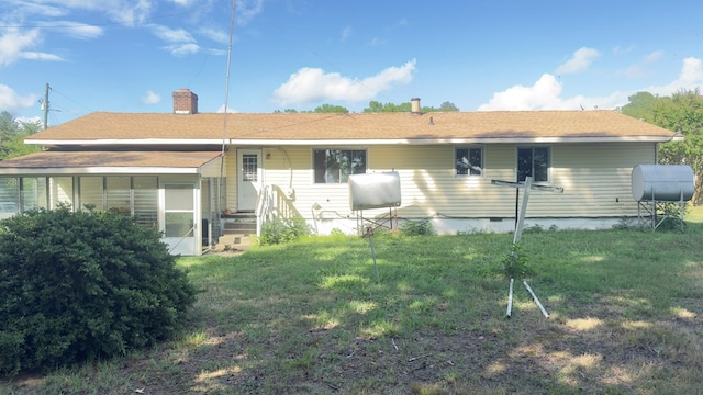 rear view of property with crawl space and a yard