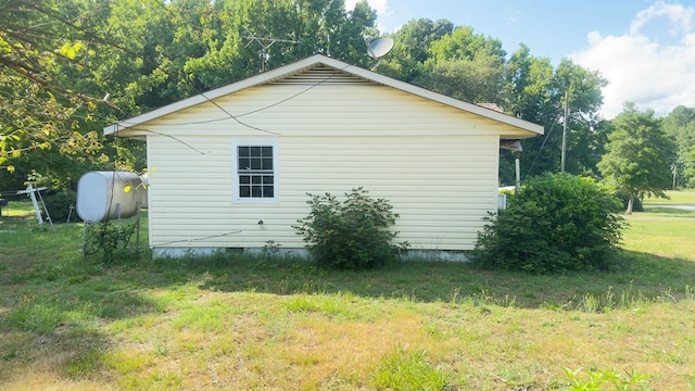 view of side of home featuring a lawn