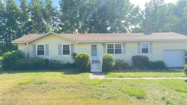 single story home with a front yard, a chimney, and an attached garage