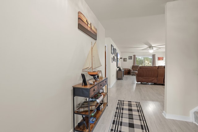 hallway with baseboards and wood finished floors