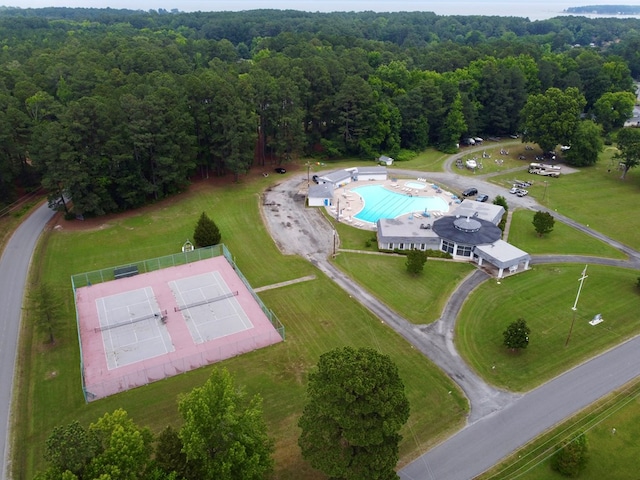 drone / aerial view featuring a wooded view