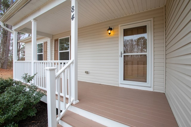 view of exterior entry with covered porch