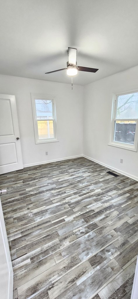 7626 Richmond Rd, Warsaw, VA 22572 - spare room featuring baseboards, ceiling fan, and wood finished floors