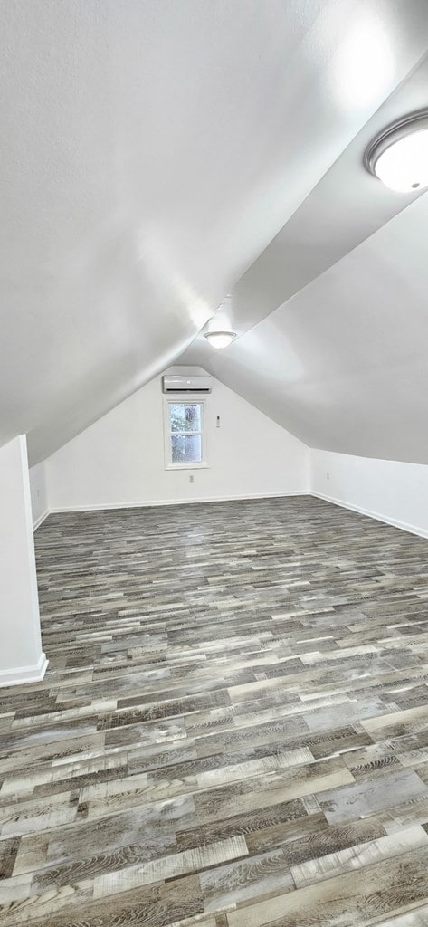 7626 Richmond Rd, Warsaw, VA 22572 - additional living space featuring baseboards, lofted ceiling, and wood finished floors