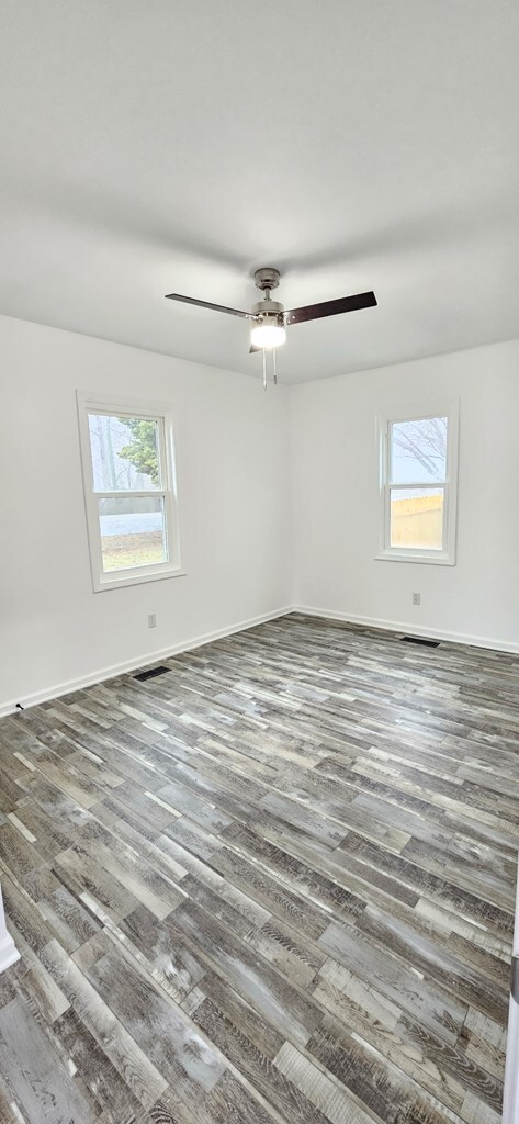 7626 Richmond Rd, Warsaw, VA 22572 - spare room featuring a ceiling fan, wood finished floors, and baseboards