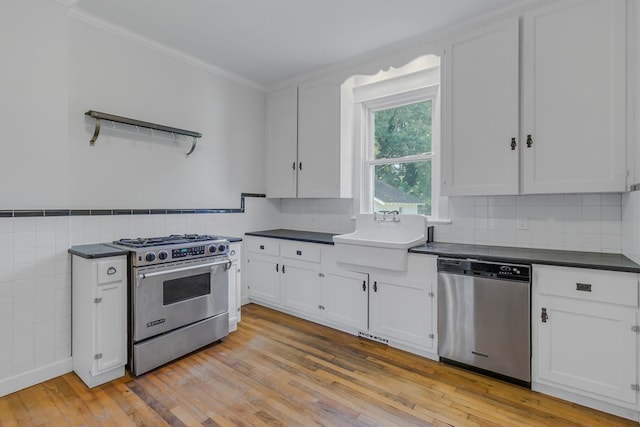 kitchen with white cabinetry, sink, stainless steel appliances, and light hardwood / wood-style floors