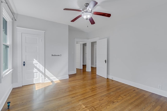 unfurnished room with light hardwood / wood-style flooring and ceiling fan