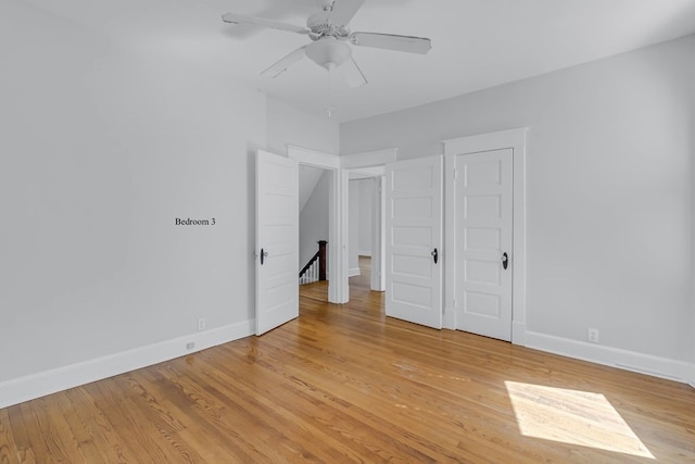 unfurnished bedroom featuring ceiling fan and light hardwood / wood-style flooring