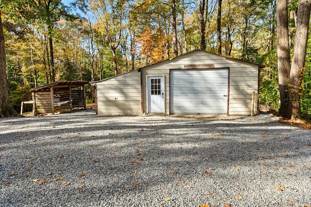 view of outdoor structure featuring a garage and a carport