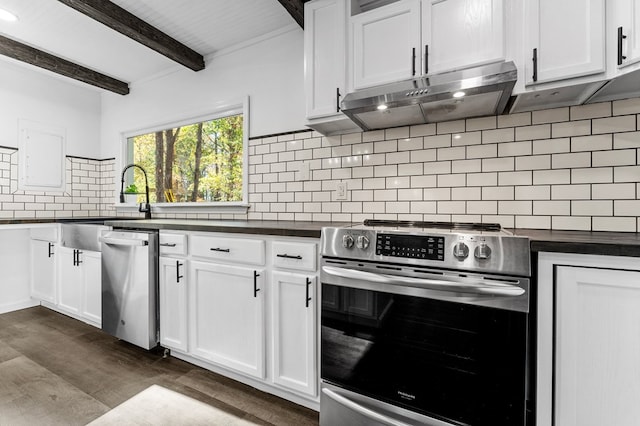 kitchen with dark wood-type flooring, white cabinets, appliances with stainless steel finishes, tasteful backsplash, and beam ceiling