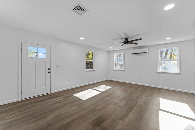 entrance foyer featuring a wall mounted air conditioner, ceiling fan, and dark hardwood / wood-style flooring