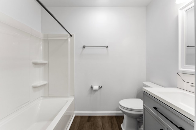 full bathroom featuring vanity, toilet, wood-type flooring, and bathing tub / shower combination