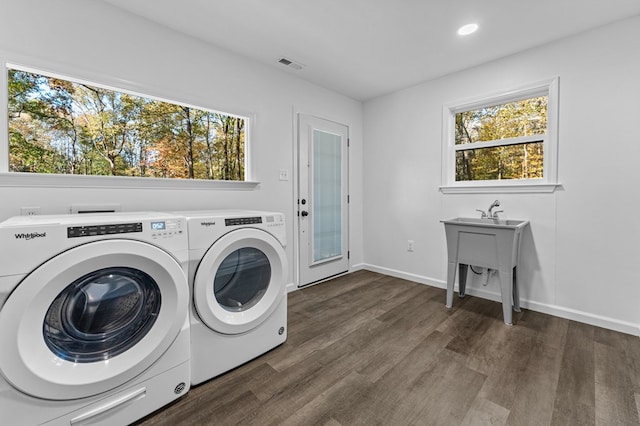 washroom featuring washer and clothes dryer, dark hardwood / wood-style floors, and plenty of natural light