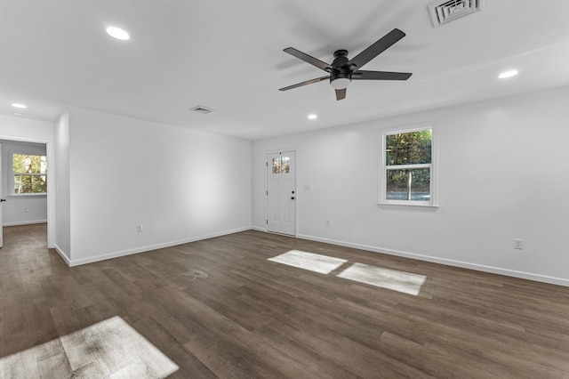 unfurnished room featuring ceiling fan and dark wood-type flooring