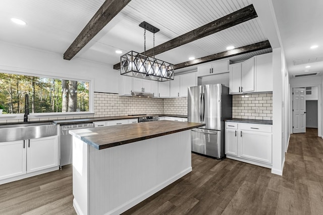 kitchen featuring stainless steel appliances, a kitchen island, sink, dark hardwood / wood-style floors, and white cabinetry