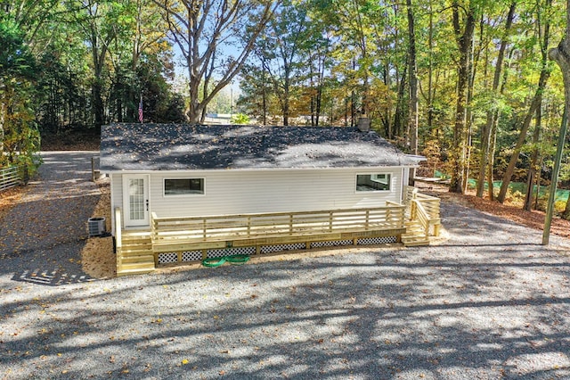 view of side of home featuring a wooden deck and cooling unit