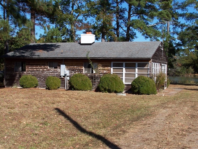 view of property exterior with a yard