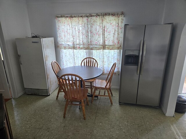 dining space featuring tile patterned floors