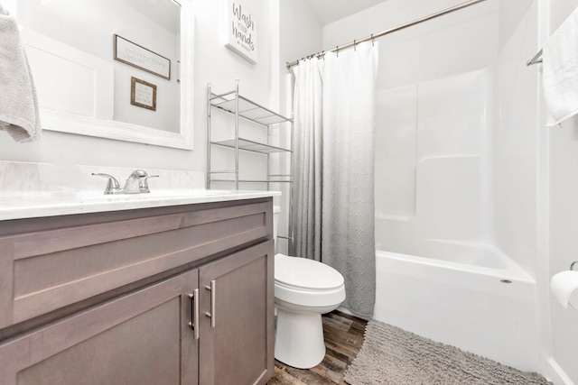 full bathroom with wood-type flooring, vanity, shower / tub combo, and toilet