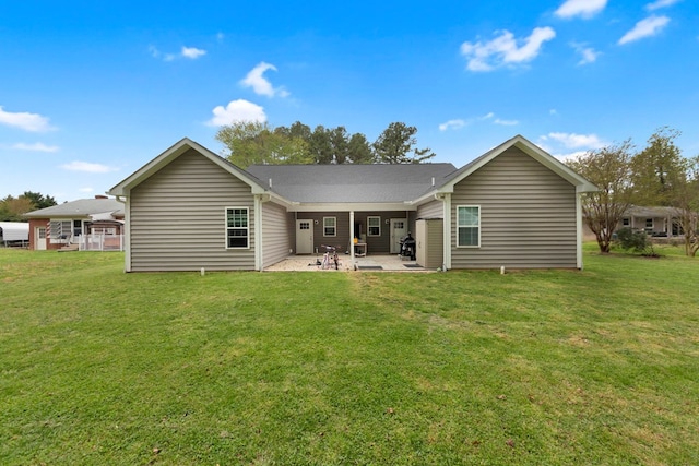 back of house with a lawn and a patio