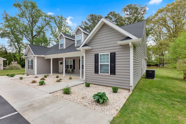 view of front facade featuring cooling unit, a front lawn, and a porch