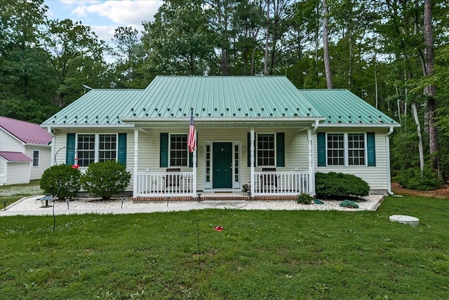 126 Pioneer Trl, Hague, VA 22469 - view of front of home with a porch, a front yard, and a metal roof