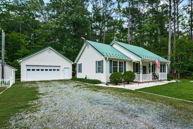 126 Pioneer Trl, Hague, VA 22469 - ranch-style home with a porch, an outbuilding, a detached garage, a metal roof, and a front lawn