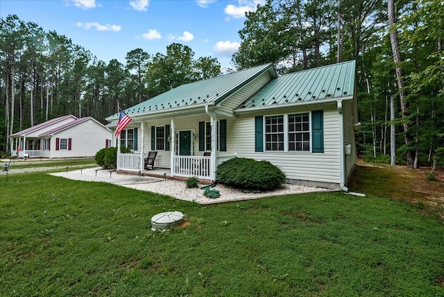 126 Pioneer Trl, Hague, VA 22469 - view of front facade featuring a porch, a front lawn, and a metal roof