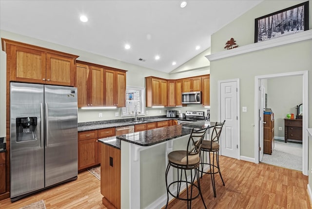 126 Pioneer Trl, Hague, VA 22469 - kitchen with stainless steel appliances, a kitchen bar, brown cabinetry, light wood-style flooring, and recessed lighting