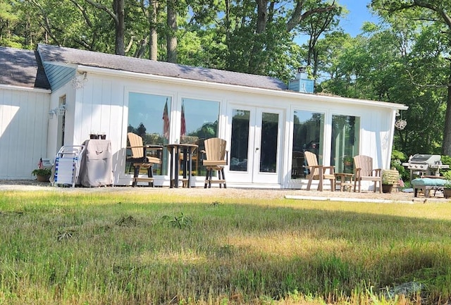 237 Hickory Ln, Reedville, VA 22539 - back of property featuring a chimney, french doors, and a shingled roof